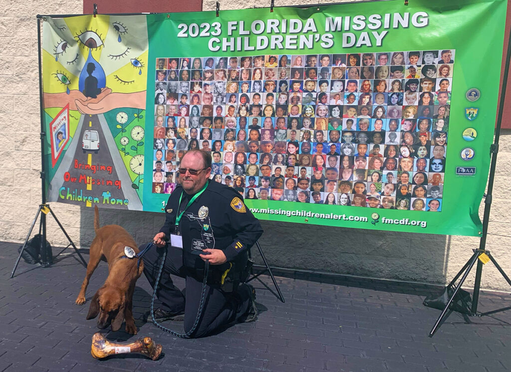 TPD Det. Paul Osborne and K9 Jon Jon pose for photos at the 25th Missing Children's Day Award ceremony in Tallahassee, FL.